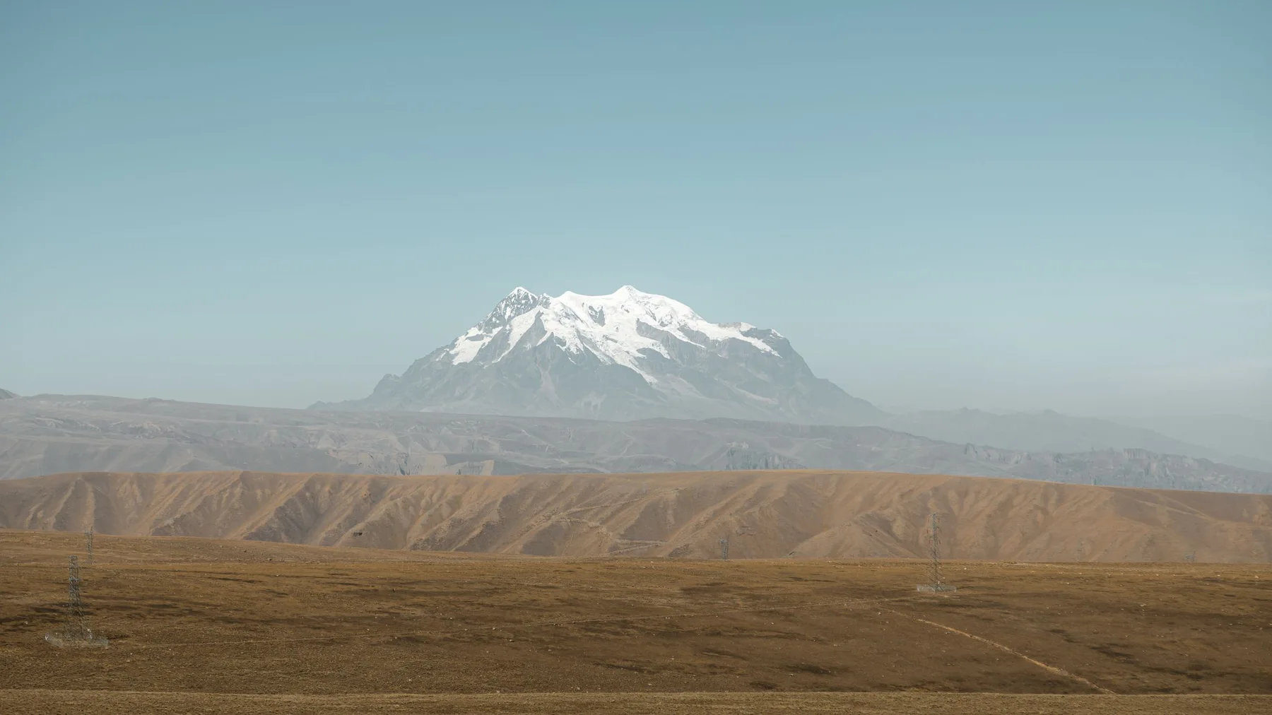 Panoramic view of Huayna Potosi with snowcapped peaks and vast plains in Bolivia.