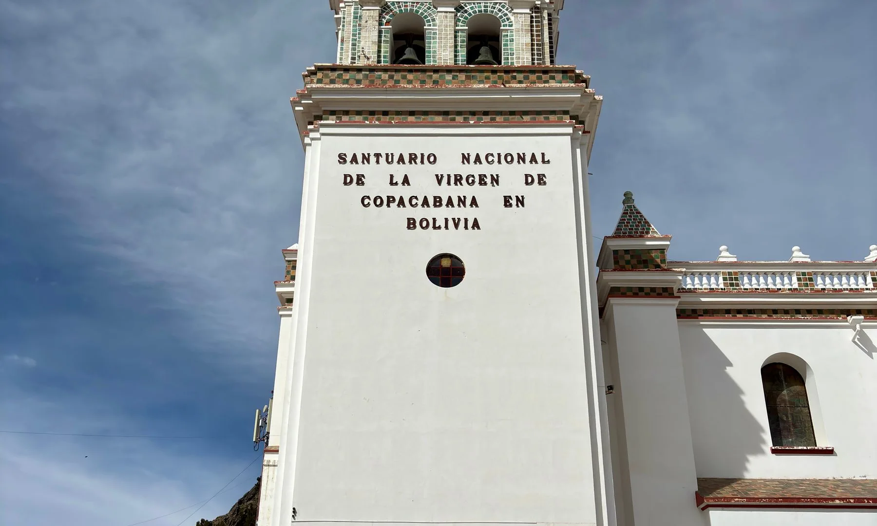 The iconic Santuario Nacional de la Virgen de Copacabana in Bolivia captured under a bright sky.
