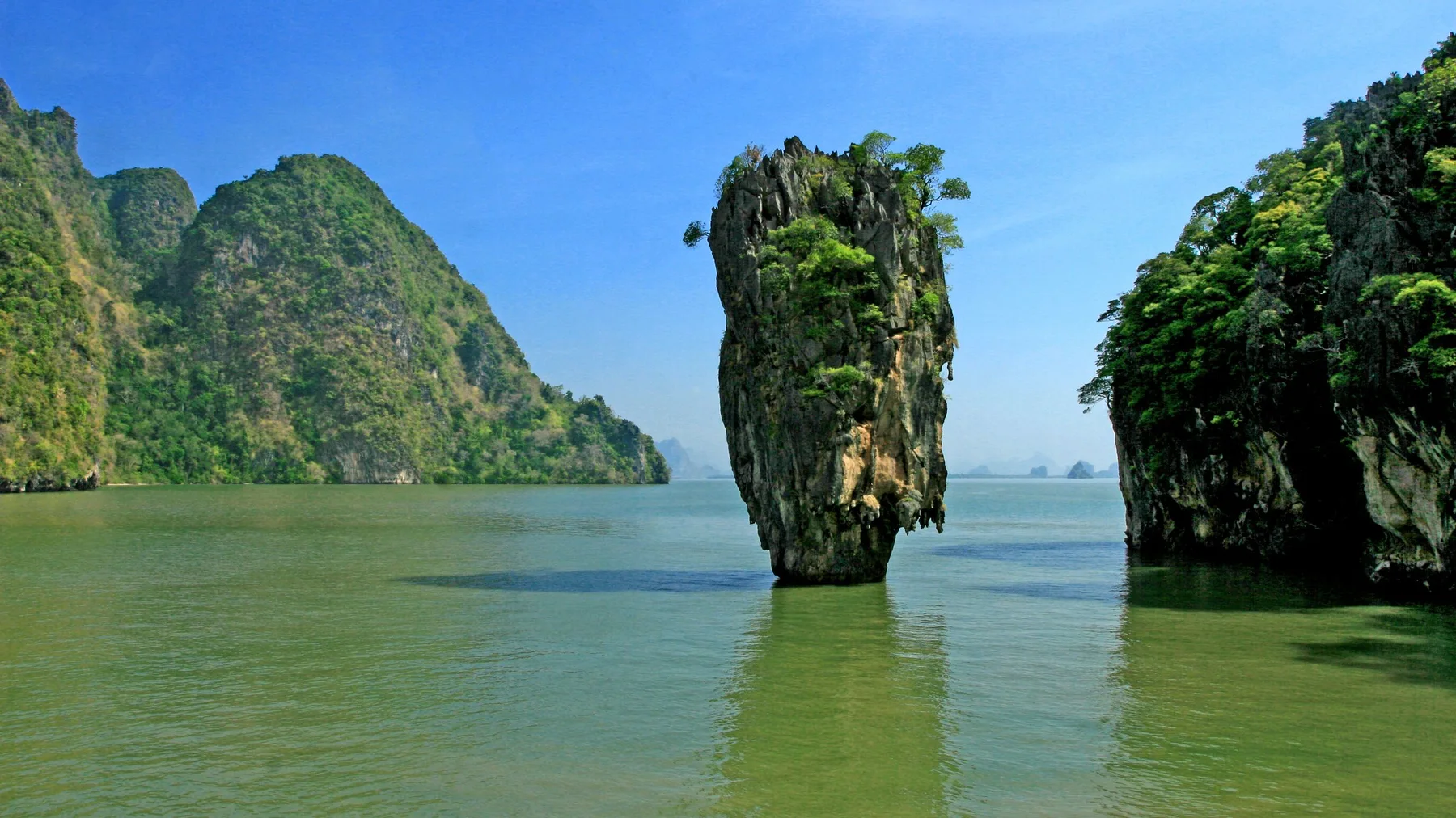 A stunning view of James Bond Island in Thailand's Phang Nga Bay with clear blue skies.