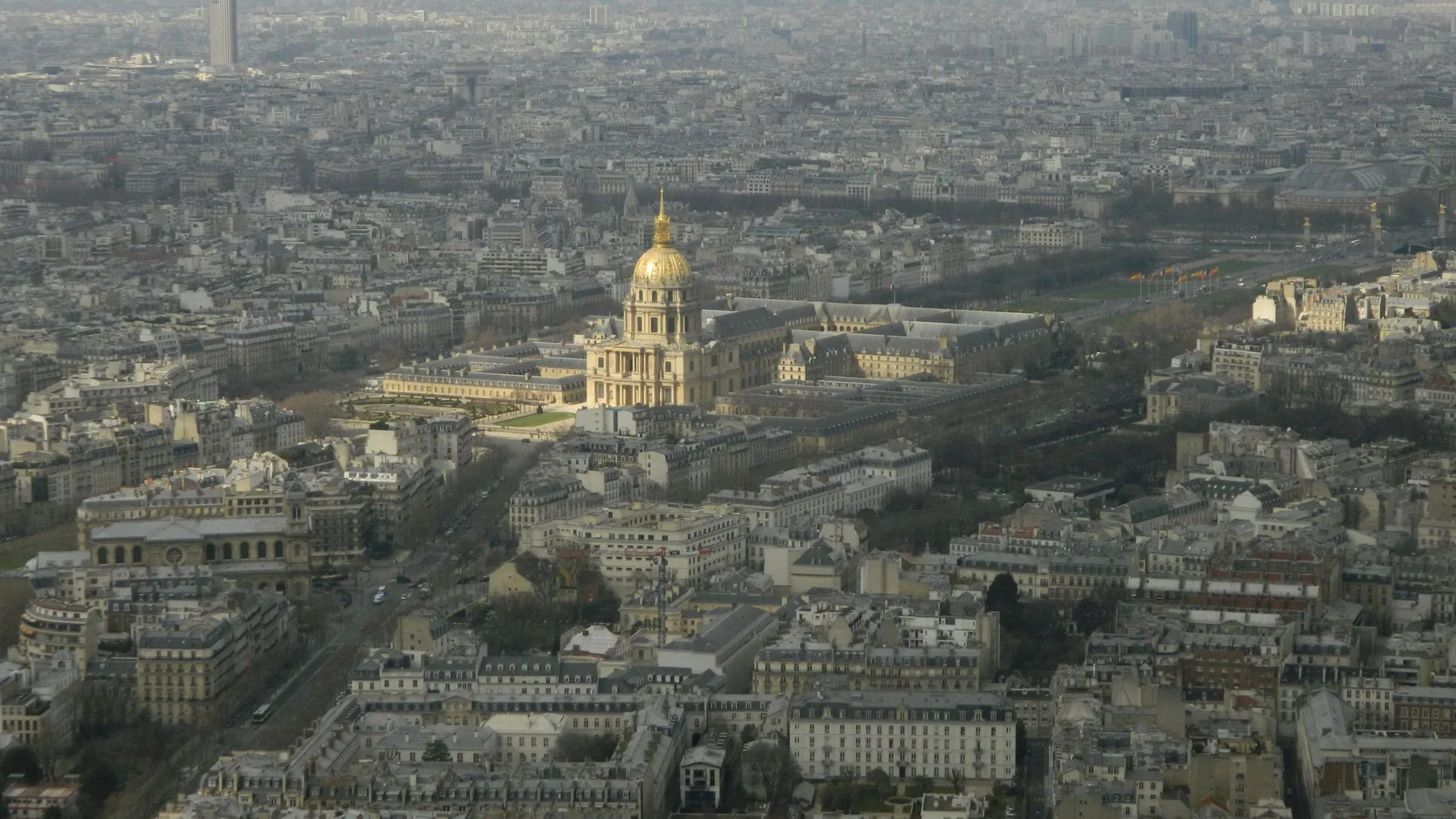 Stunning aerial view of Les Invalides in Paris, highlighting the iconic golden dome amidst the cityscape.
