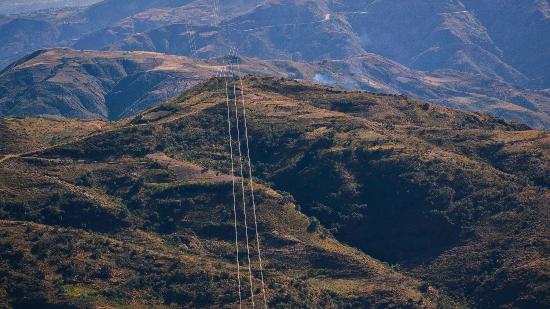 Beautiful mountain view from Cochabamba, Bolivia with power lines stretching across the landscape.
