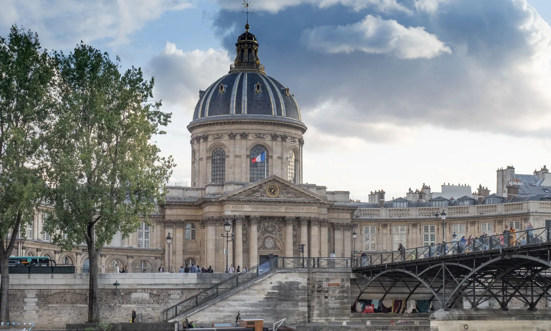 Stunning view of the historic Institut de France in Paris with a dramatic sky.