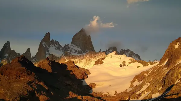 Stunning landscape of snow-capped Andes mountains and lake at sunrise in Argentina.