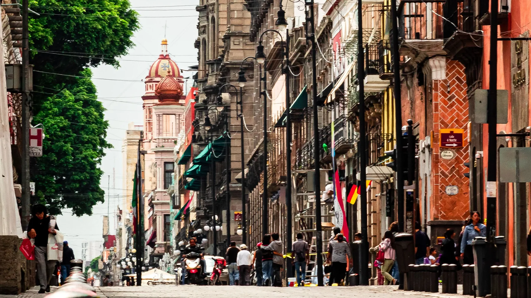 Vibrant street view showcasing colonial architecture in Puebla, Mexico.